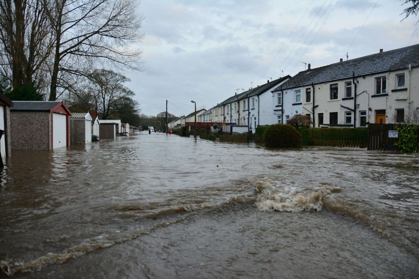 white and brown concrete building near body of water during daytime, flood, house